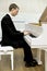 Elegant young pianist playing piano