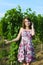 elegant young woman outdoor portrait lean on wall covered in vines