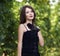 elegant young woman outdoor portrait lean on wall covered in vines