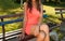 Elegant Young Woman on a Retro Bench in the Park - Summer Sunset