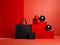 Elegantly arranged black handbag on red background, store window for black Friday