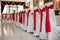 Elegantly catered wedding reception hall with red ribbons on lux