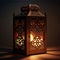 Elegantly decorated square lantern glowing on a dark background. Lantern as a symbol of Ramadan for Muslims