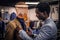 Elegantly dressed African-American man working at classic menswear store.