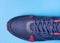 Elegants mans sport sneaker on blue background isolated. Top vew