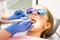 Elementary age girl receiving teeth cleaning procedure in pediatric dental clinic