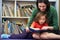 Elementary Pupil Reading With Teacher In Classroom