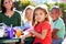 Elementary Pupils And Teacher Eating Lunch