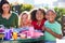 Elementary Pupils And Teacher Eating Lunch