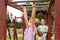 Elementary school age child exercising, climbing, playing on the playground, portrait, closeup. Children and healthy activity