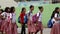 Elementary school children stand in line as they are taught to behave during building fire situation