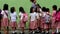 Elementary school children stand in line as they are taught to behave during building fire situation