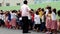 Elementary school children stand in line as they are taught to behave during building fire situation