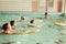 Elementary school children within swimming skills lesson.