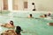 Elementary school children within swimming skills lesson.