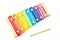Elementary school educational play conceptual idea with colorful xylophone painted in rainbow colors and mallet used to hit the