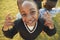 Elementary school girl posing to camera outdoors, high angle