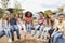 Elementary school kids sitting on carousel in the schoolyard