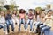 Elementary school kids sitting on carousel in the schoolyard