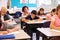 Elementary school kids working at their desks in a classroom