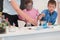 Elementary School Science Classroom: Enthusiastic Teacher Explains Chemistry to Diverse Group of Children, Little Boy