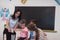 Elementary School Science Classroom: Enthusiastic Teacher Explains Chemistry to Diverse Group of Children, Little Boy