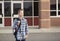 Elementary school student standing outside the school building