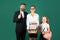 Elementary school teacher and girl students portrait isolated on blackboard.