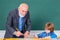 Elementary school teacher giving female pupil support in classroom. Individual teaching.