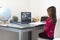 Elementary schooler child girl at home with laptop for remote connection with her classmates and the teacher - Little girl