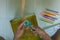 Elementary student sharpen the color pencil into the dustpan