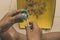 Elementary student sharpen the color pencil into the dustpan