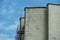 Elements and details of the exterior of a reinforced concrete building against a blue sky background. Brutal Soviet architecture