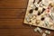 Elements of different board games on wooden table, flat lay. Space for text