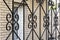 Elements are fragments of a detail of a forged black painted decorative fence made of metal. House fencing, grille, protection,