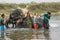 Elephant drover washes a Nepalese elephant in the river of Chitwan National Park in southern Nepal. Elephant sprinkles water from