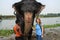 Elephant drover washes a Nepalese elephant in the river of Chitwan National Park in southern Nepal. Elephant sprinkles water from