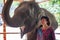 Elephant farm, girl with an elephant, young Caucasian woman feeding an elephant