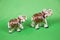 Elephants white ceramic, decorated with rhinestones, bright colors on a light green background