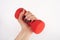 Elevate Your Fitness: Red Dumbbell in Young Female Hand