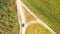 Elevated Aerial View Of Blue Car Vehicle Automobile In Fast Drive Motion On Countryside Country Road Through Summer Corn