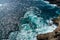 Elevated, birds eye view of ocean water surface with tough waves