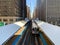 Elevated `el` train arriving at the Adams/Wabash station in Chicago south loop during spring morning