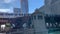 Elevated `el` train, Chicago`s transit system, crosses Wells Street over the Chicago River as pedestrians walk