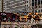 Elevated `el` train crosses Wells Street and Wacker Drive above the Chicago River.