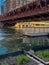 Elevated `el train crossing the Chicago River where a plastic bottle floats