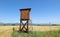 Elevated observation hut for hunters among agricultural fields