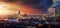 Elevated, panoramic view to the lit skyline of London, United Kingdom, during sunset time