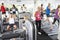 Elevated View Of Busy Gym With People Exercising On Machines