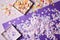 elevated view of confetti pieces in paper boxes and violet surface